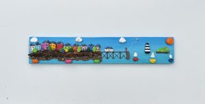 Beaumaris colourful houses, pier with a couple flying a kite and sail boats by www.Deborah Kempton.co.uk