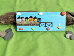 small pebblescape of beaumaris colourful houses pier and boats