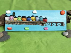 pebblescape of beaumaris' colourful houses, pier and boats